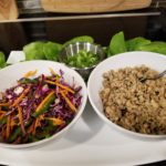 bowls of seasoned chicken and a julienne blend of colorful vegetables